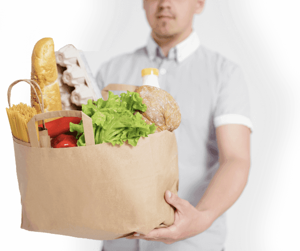 Shopper holding a bag of groceries